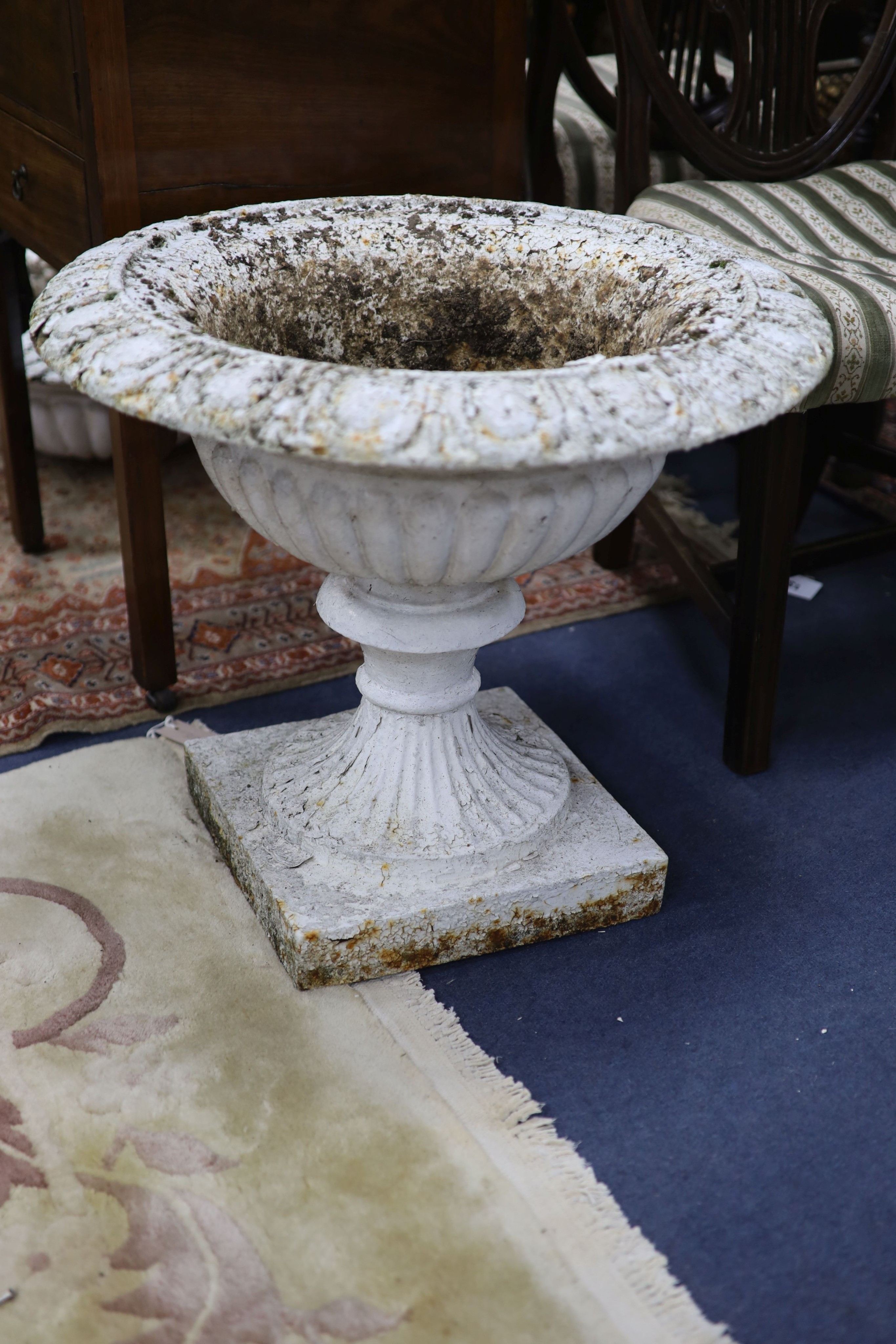 A pair of Victorian cast iron garden urns, one lacking base, 60.5 cm diameter